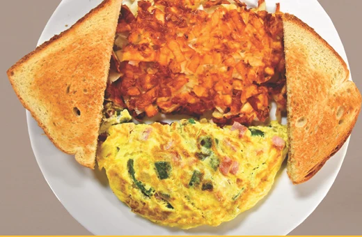 Vegetable omelette with hash browns and toast